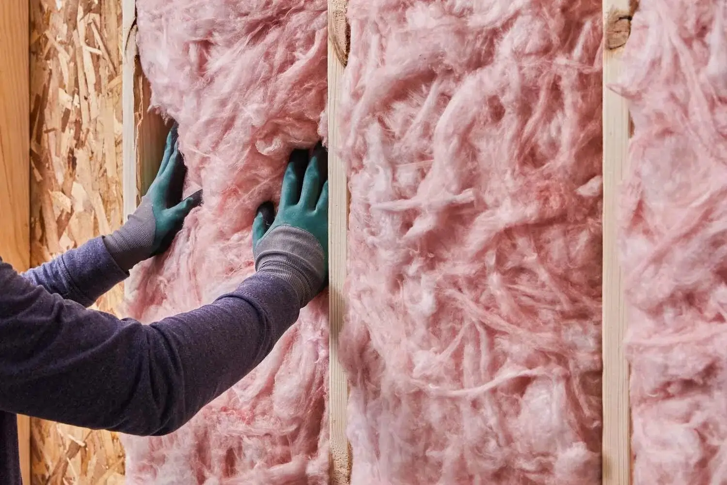 Rolls of pink fiberglass insulation